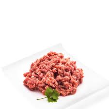 "Raw pork mince displayed in a bowl, showcasing its fine texture and bright pink color, surrounded by fresh herbs and garlic for seasoning."